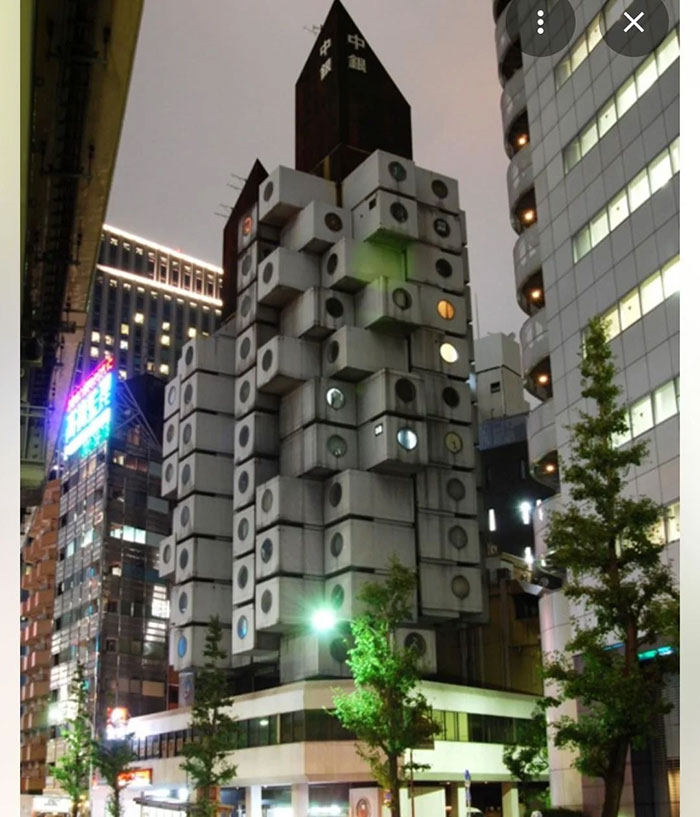 Modular concrete building at night, an example of architectural malpractice and controversial ugly design in urban area.