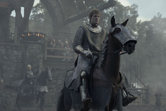 Knight of the Seven Kingdoms episode 4 scene showing Ser Duncan in armor riding a horse during a medieval tournament.