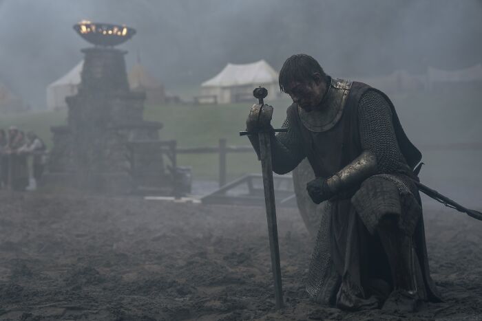 A Knight Of The Seven Kingdoms Episode 5 scene with a knight kneeling in armor holding a sword in a foggy battlefield. A Knight Of The Seven Kingdoms Episode 5 scene with a knight kneeling in armor holding a sword in a foggy battlefield.