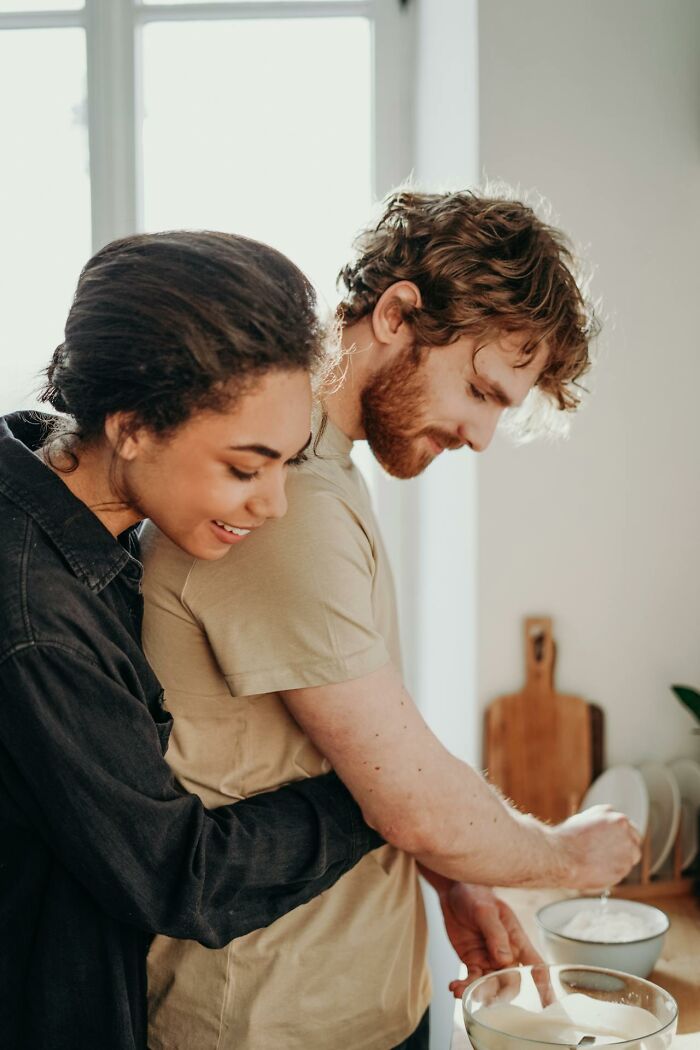 Couple showing respect and affection while baking together, highlighting married men’s reactions to attraction.