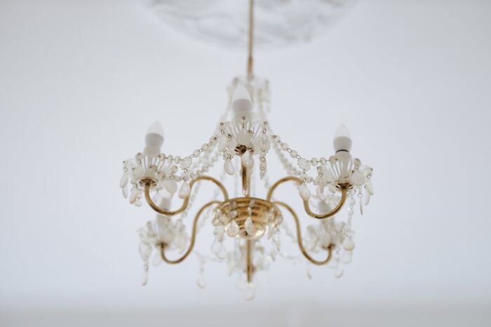 Elegant vintage chandelier with crystal beads hanging from ceiling, evoking strange things people witnessed from another world.