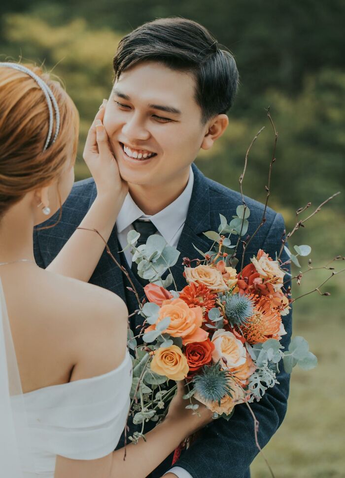 Couple sharing a tender moment with a colorful bouquet, illustrating how people silently judge others in relationships.