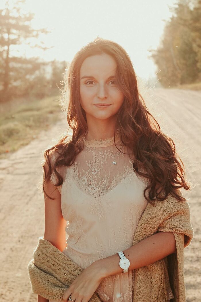 Young woman with long hair wearing a lace top and cardigan outdoors, reflecting self-respect and partner respect themes