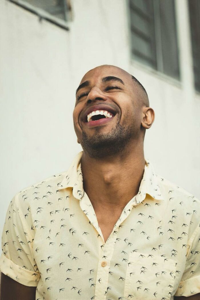Smiling man in a patterned shirt expressing positive emotions about respect in relationships and married men’s reactions.