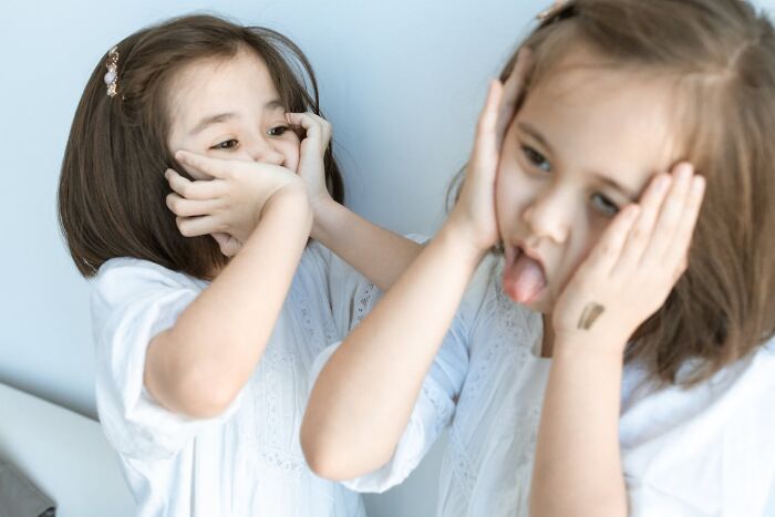 Two young girls making scared and confused faces, illustrating feelings often experienced by graveyard shift workers.