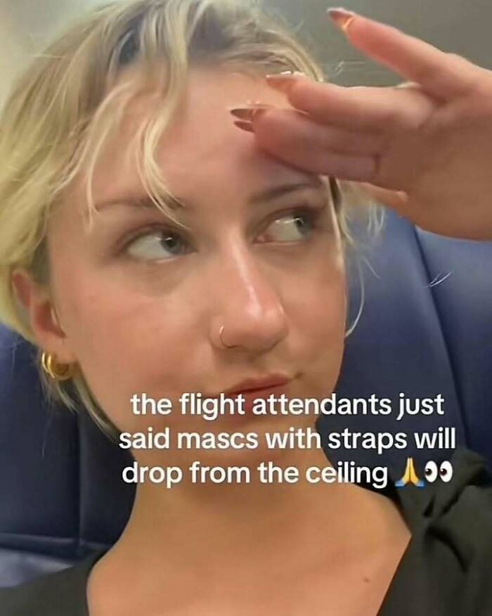 Young woman on a plane reacting to a funny meme about flight attendants and masks dropping from the ceiling.