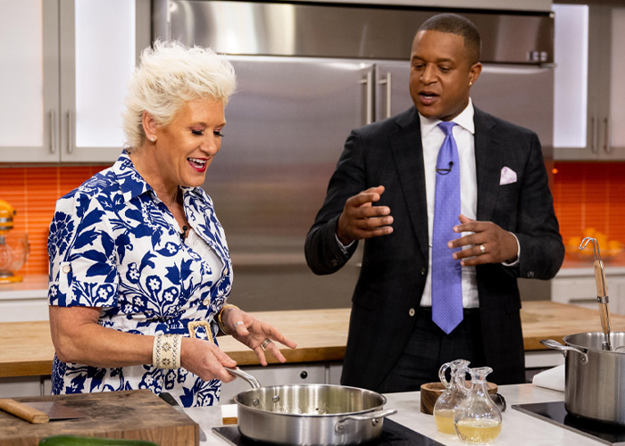 Anne Burrell in a kitchen setting with a man in a suit, preparing food while discussing details related to police reports. Anne Burrell in a kitchen setting with a man in a suit, preparing food while discussing details related to police reports.