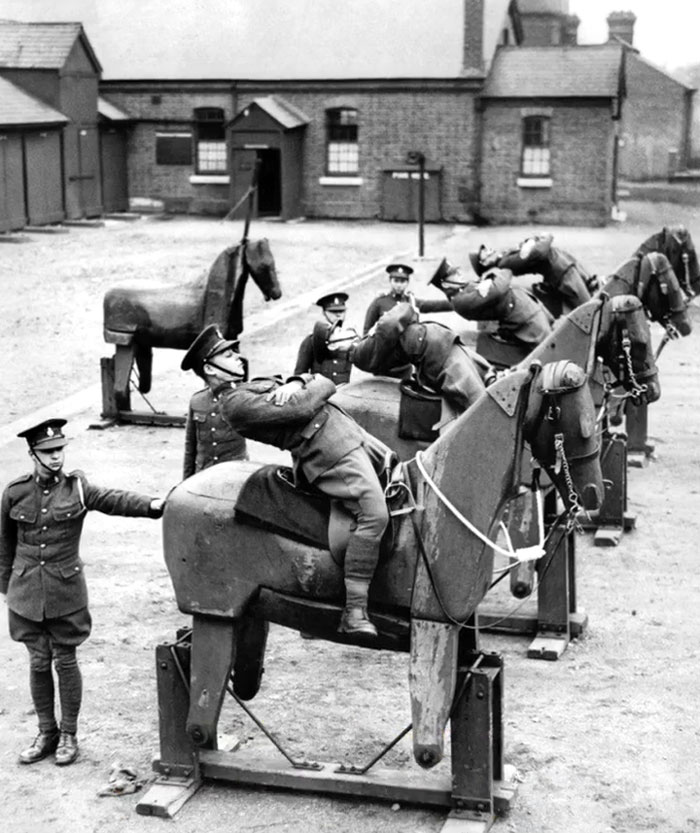 Soldiers practicing mounting wooden horses as a rare and intriguing moment in history between the headlines.
