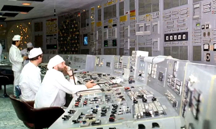 Control room operators monitoring panels filled with switches and gauges in a rare and intriguing photo from history.