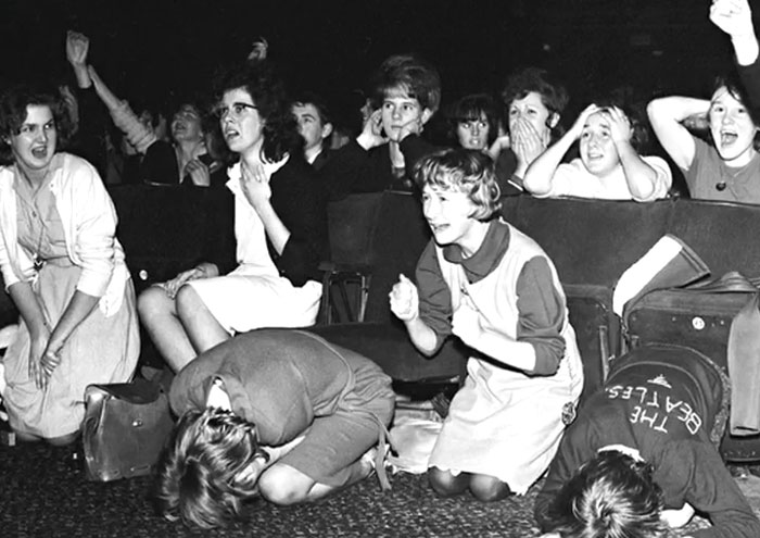 Crowd of people showing intense emotions during a rare and intriguing historic moment captured in a black and white photo.
