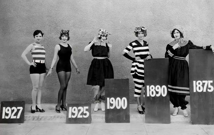 Five women in vintage swimsuits pose next to blocks labeled with years, showcasing rare and intriguing historical photos.