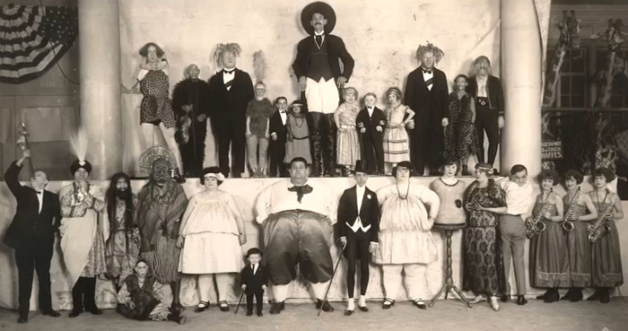 Vintage group photo featuring performers and entertainers, a rare and intriguing image showing history between the headlines.