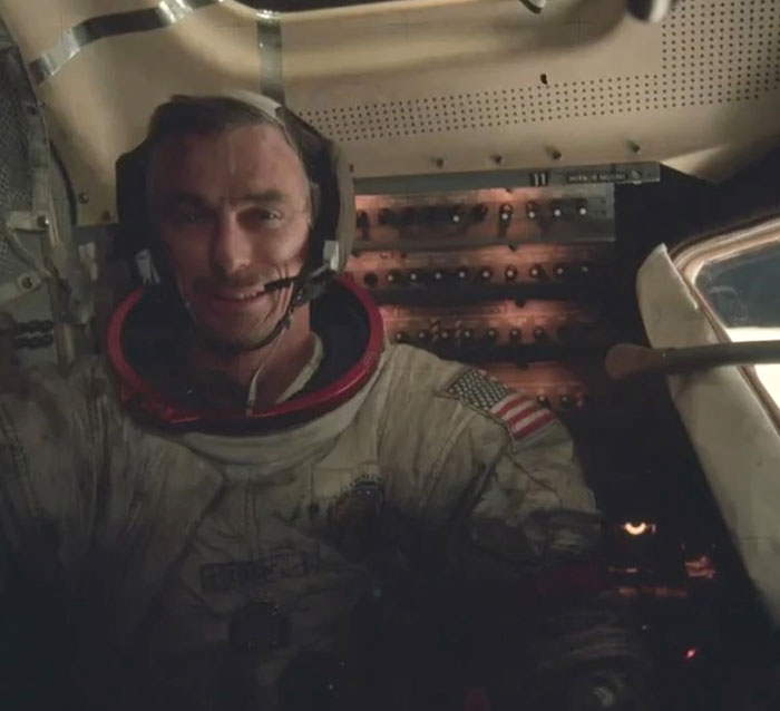 Astronaut in spacecraft cockpit wearing helmet and space suit, a rare and intriguing photo showing history behind headlines.