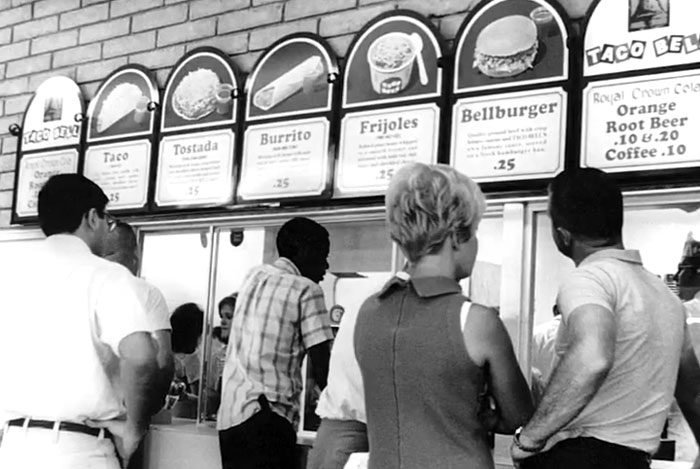 Customers in line at a vintage Taco Bell counter showcasing rare and intriguing photos of history between the headlines.