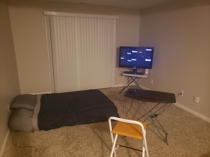 Sparse room with mattress on floor, small TV on stand, and minimal furniture showing common red flags in someone's home.