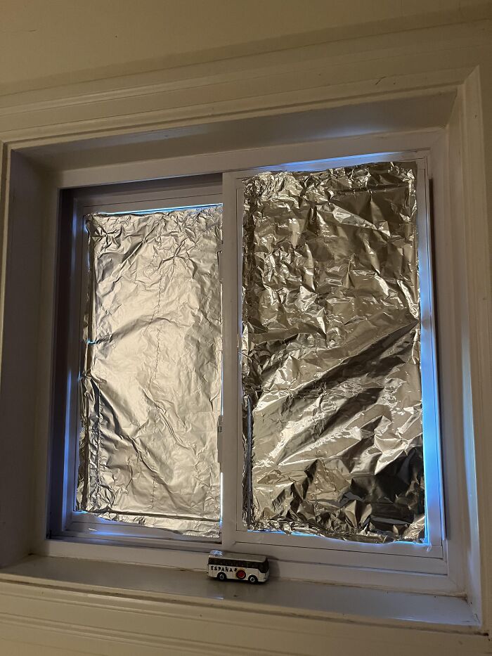 Window covered with crumpled aluminum foil, a red flag that screams turn around and leave in someone’s home.