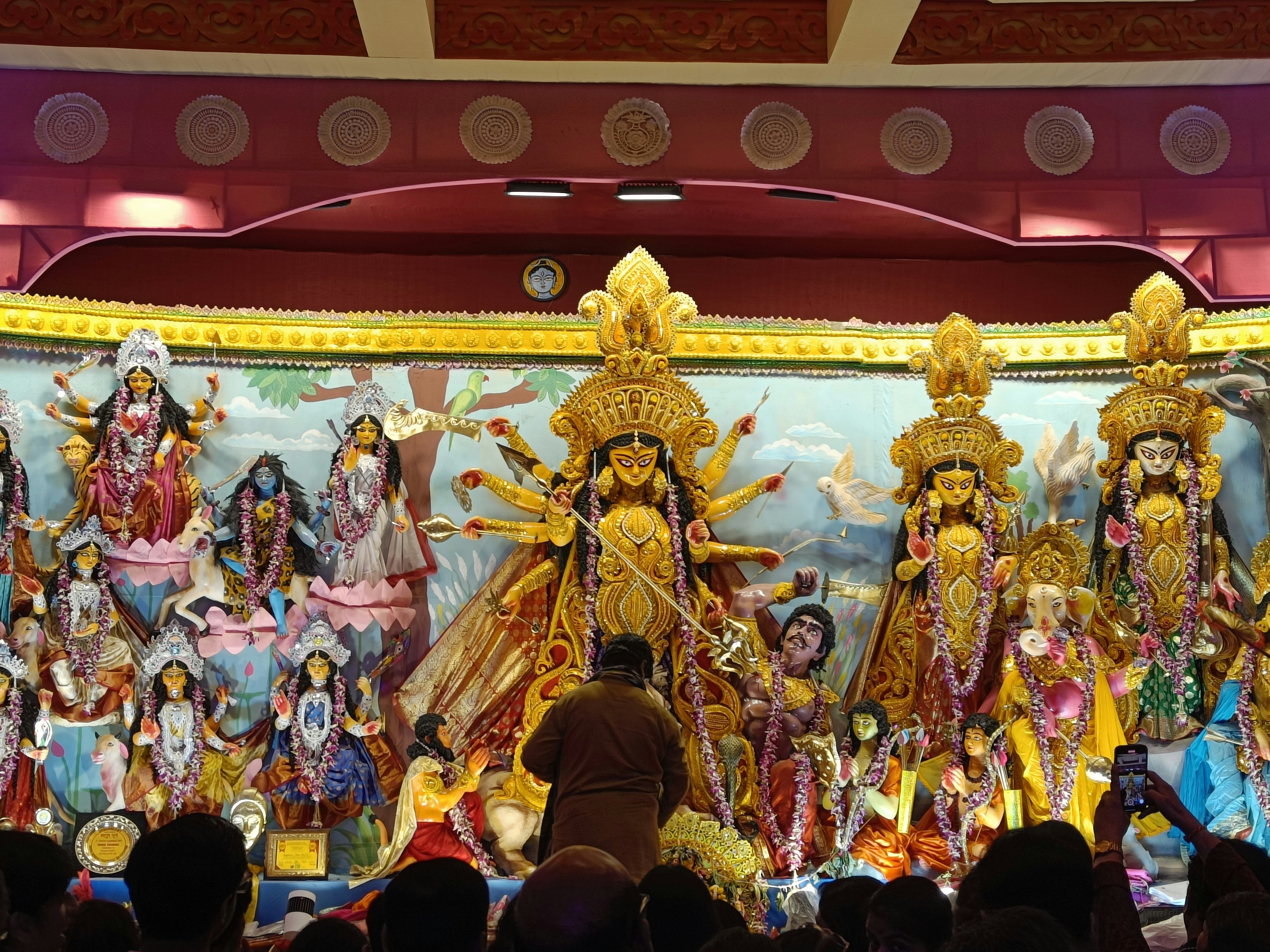 Colorful statues of Hindu deities displayed during a cultural festival, highlighting spiritual tourism in India.