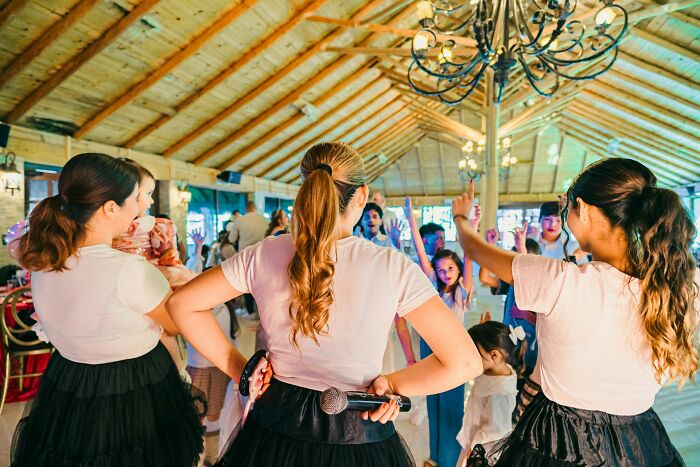 Group of people enjoying a cultural event indoors, showcasing traditions and activities common in their country.