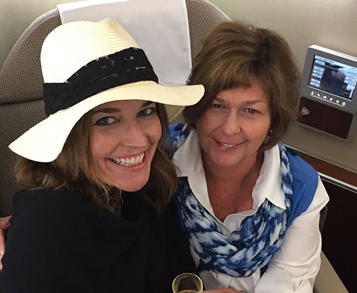 Two women smiling together, one wearing a white hat and the other with a blue scarf, related to Savannah Guthrie mom search.