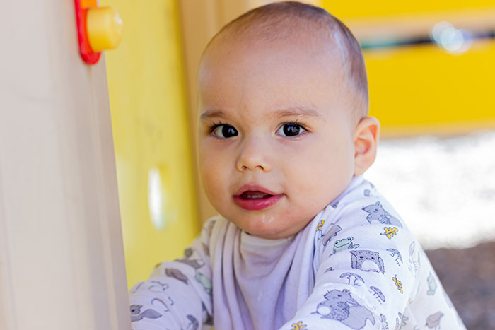 Close-up of a young child playing outdoors, reflecting on autism and reconsidering becoming a mother.