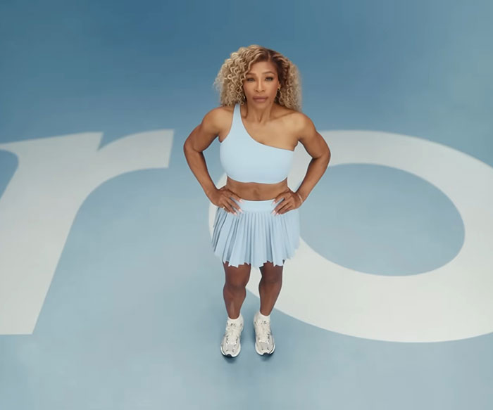 Serena Williams posing in a light blue athletic outfit amid controversial weight loss transformation and Super Bowl ad backlash.