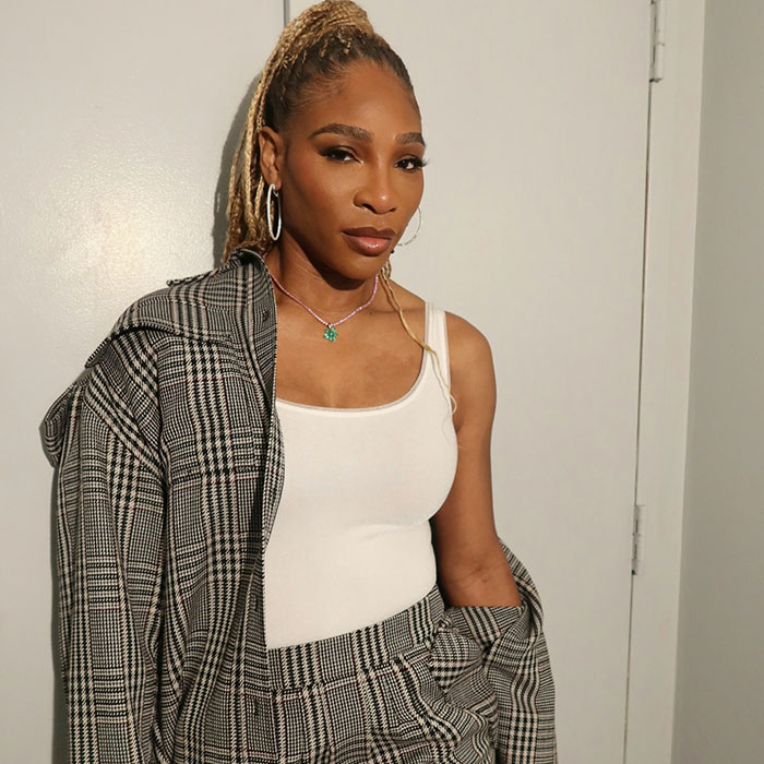 Serena Williams posing in a plaid suit and white tank top amid controversial weight loss and Super Bowl ad criticism.