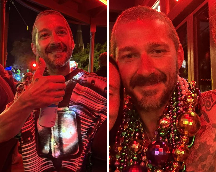 Shia LaBeouf at a lively event in New Orleans, showing a thumbs up and wearing colorful bead necklaces.