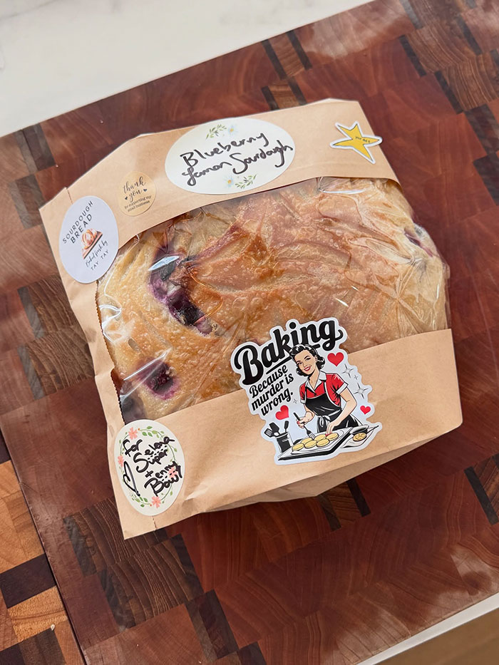 Blueberry lemon sourdough bread gift wrapped on a wooden cutting board, linked to Taylor Swift and Selena Gomez backlash.