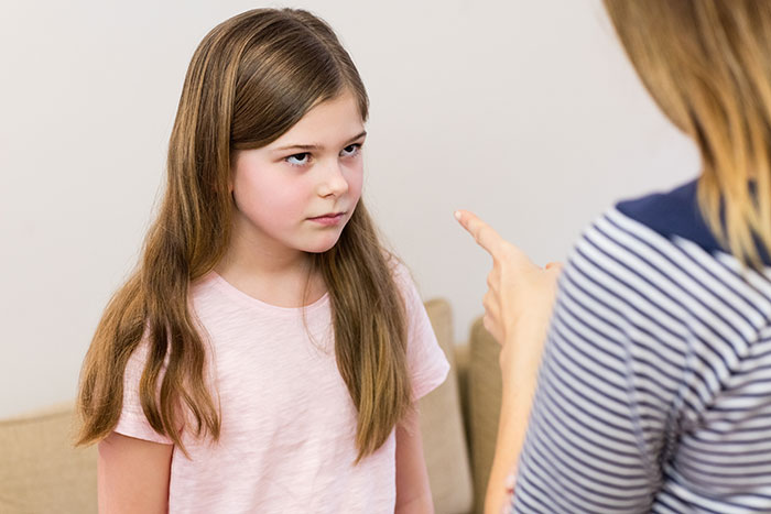 Young stepdaughter looking upset while being confronted about cheating and lies, reflecting a broken relationship moment.