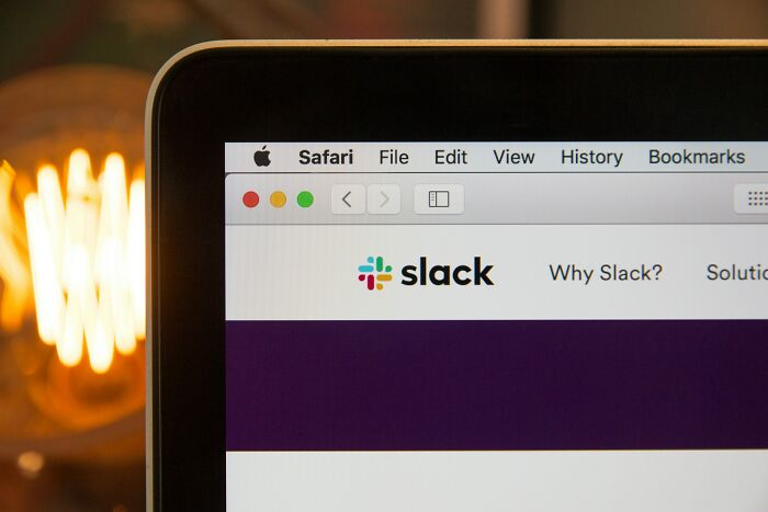 Close-up of a laptop screen showing Slack on Safari browser, illustrating brutal wake-up calls to leave nasty situations.