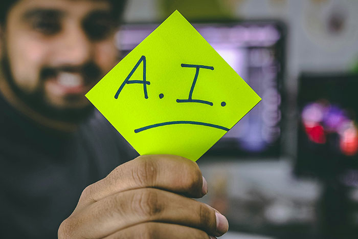 Person holding a sticky note with A.I. written on it, representing conspiracy theories about artificial intelligence.