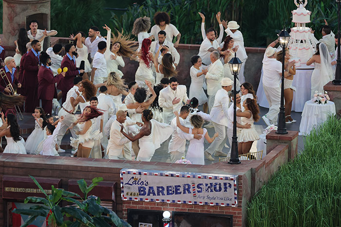 Crowd dressed in white dancing energetically, capturing the excitement of Bad Bunny's Super Bowl halftime show wedding.