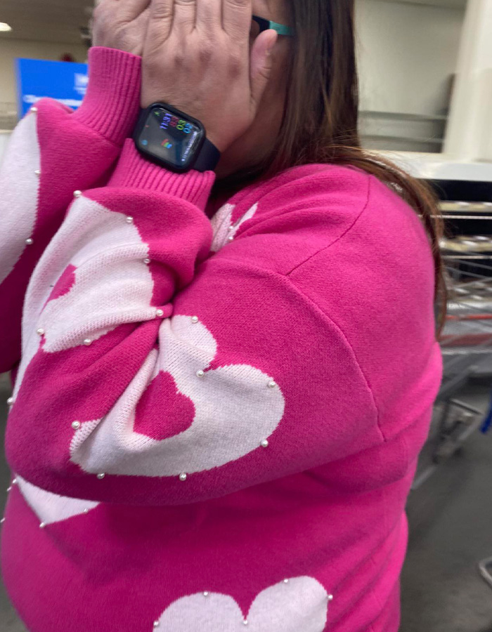 Woman in a pink sweater covering her face, related to teacher jailed over alleged racist attack incident. Woman in a pink sweater covering her face, related to teacher jailed over alleged racist attack incident.