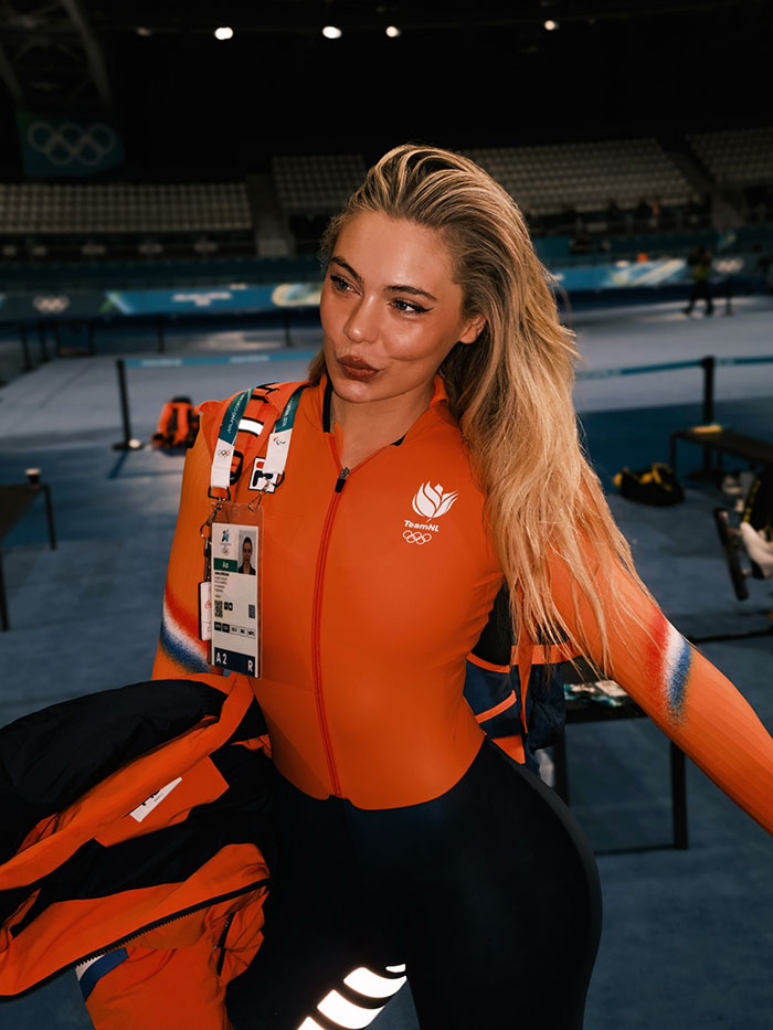 Jutta Leerdam in Team NL Olympic suit indoors, posing confidently as fans discuss earnings and underwear reveal. Jutta Leerdam in Team NL Olympic suit indoors, posing confidently as fans discuss earnings and underwear reveal.