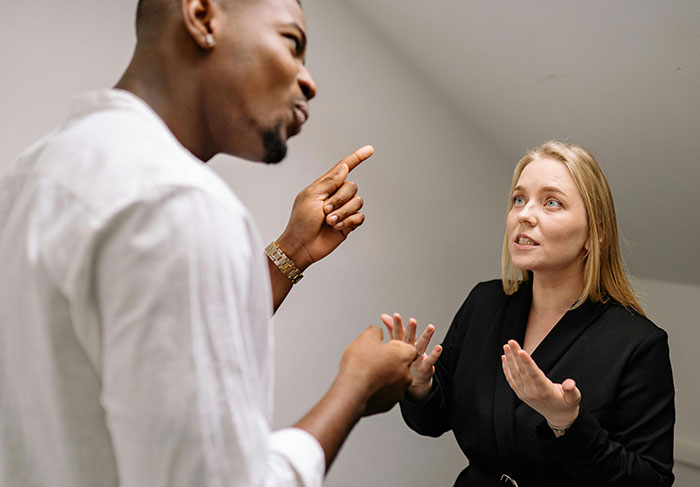 A man and woman having a tense conversation, illustrating common behaviors of a man-child in relationships.