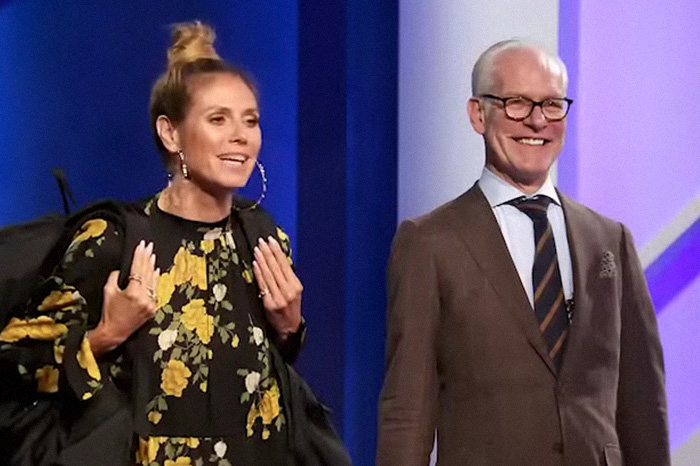 Tim Gunn smiling in a brown suit with a woman in a floral dress, highlighting celibacy and personal revelation.