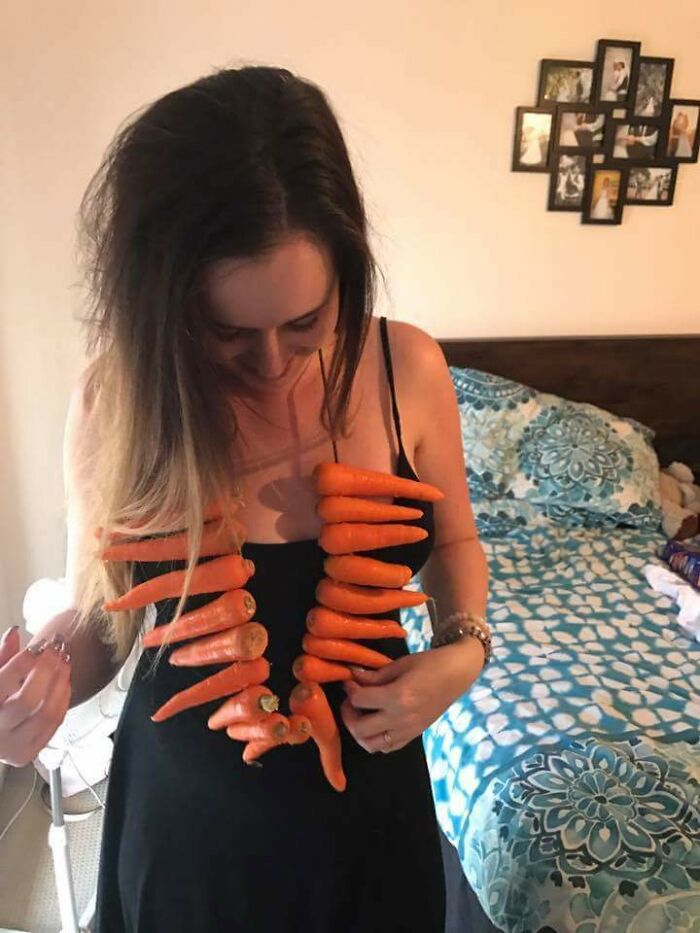 Woman in black dress wearing a necklace made of carrots, showcasing a ridiculously funny Valentine’s Day gift idea.