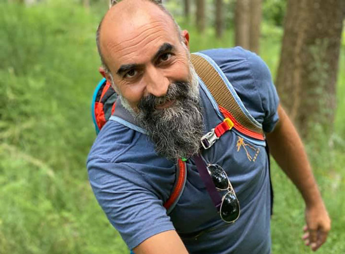 Man with beard and backpack hiking in forest, related to Savannah Guthrie&rsquo;s brother-in-law missing mom case suspects.