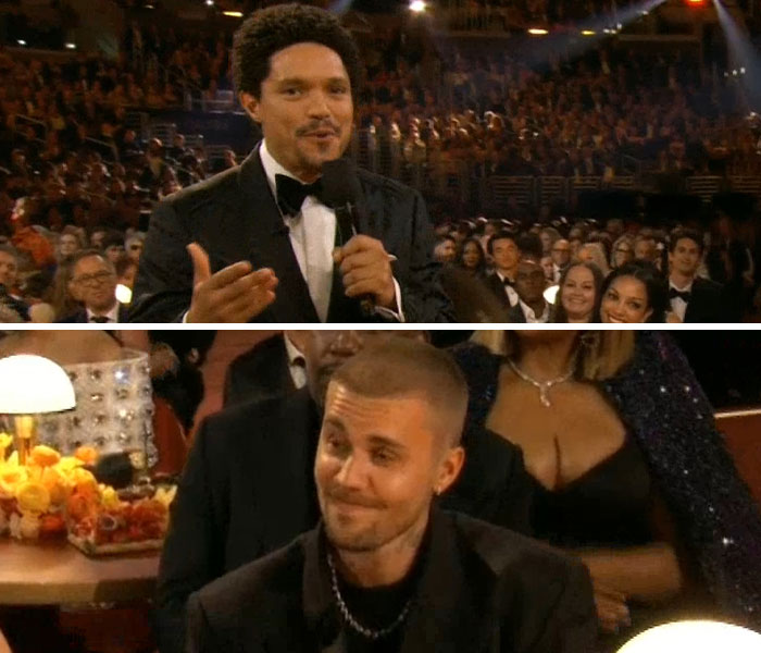 Host speaking into a microphone while a male celebrity reacts awkwardly during the Grammy Awards 2026 event.