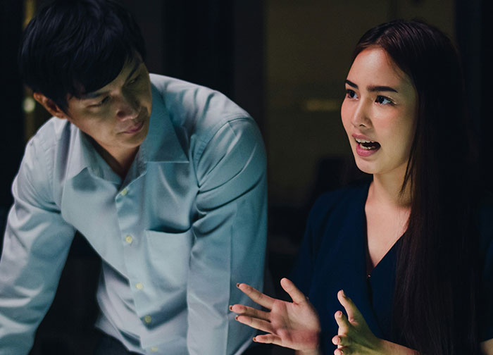 Man talking to wife in discussion at home after learning about her work nickname so embarrassing.