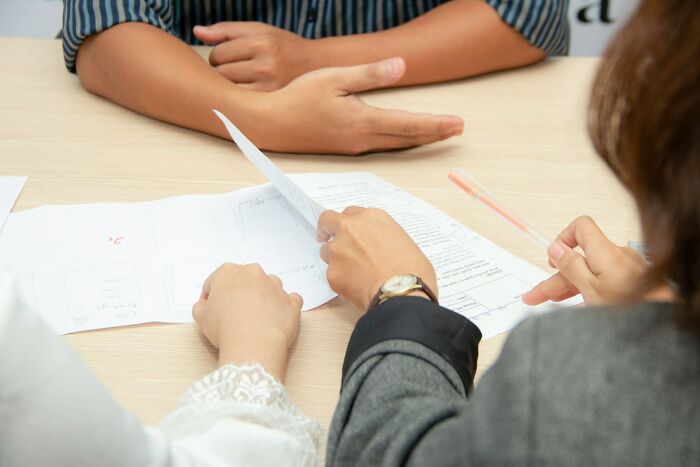Two people reviewing documents at a table, illustrating brutal wake-up calls that prompted immediate action.