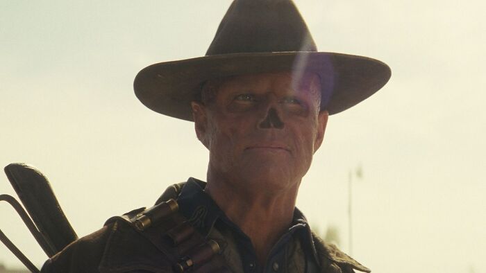 Character wearing a wide-brimmed hat and gear in a post-apocalyptic setting linked to Fallout Season 3 Colorado games. - 1