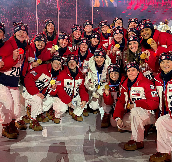 US women's hockey players posing with gold medals, celebrating their victory and breaking silence on Trump's remark.