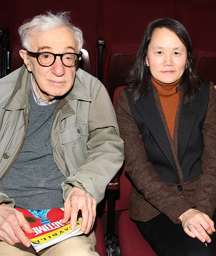 An elderly man with glasses and a woman sitting side by side in an auditorium, related to Timoth&eacute;e Chalamet Epstein files.