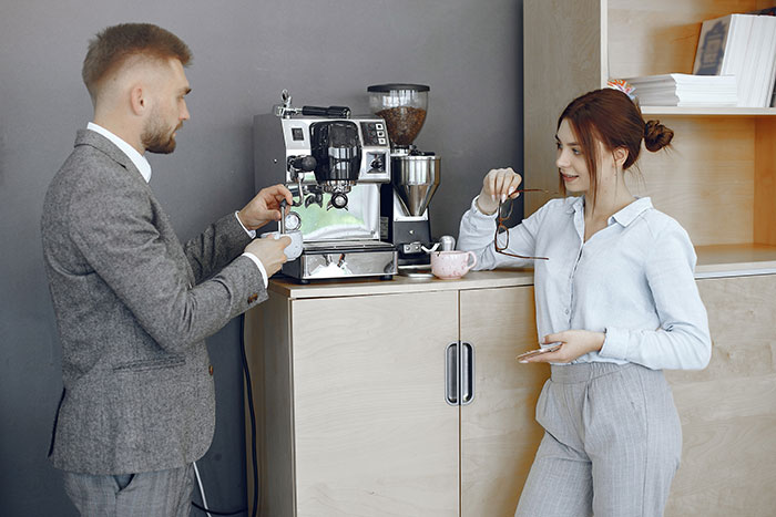 Man and woman bonding over coffee machine, reflecting on friendship and tragic story behind a crude drawing.