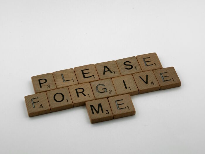 Scrabble tiles spelling out please forgive me on a white surface for a Would You Still Do It Poll concept.