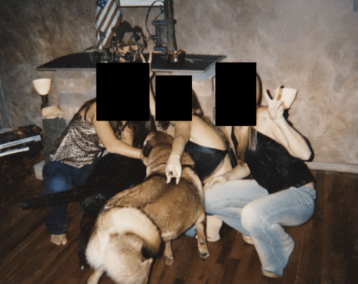 Three people with faces obscured sit on a wooden floor with dogs, related to sulfuric acid purchase for Epstein Island FBI probe.