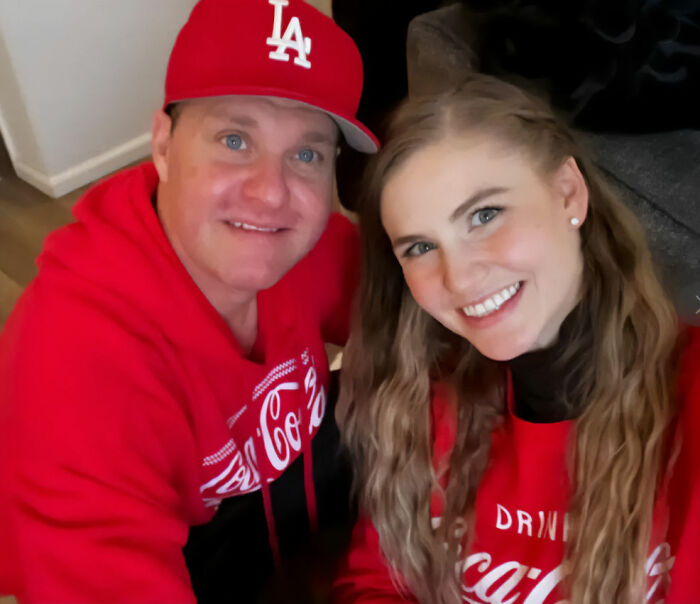 Zachery Ty Bryan, Home Improvement star, wearing a red LA cap and red Coca-Cola hoodie, smiling in a casual indoor setting.