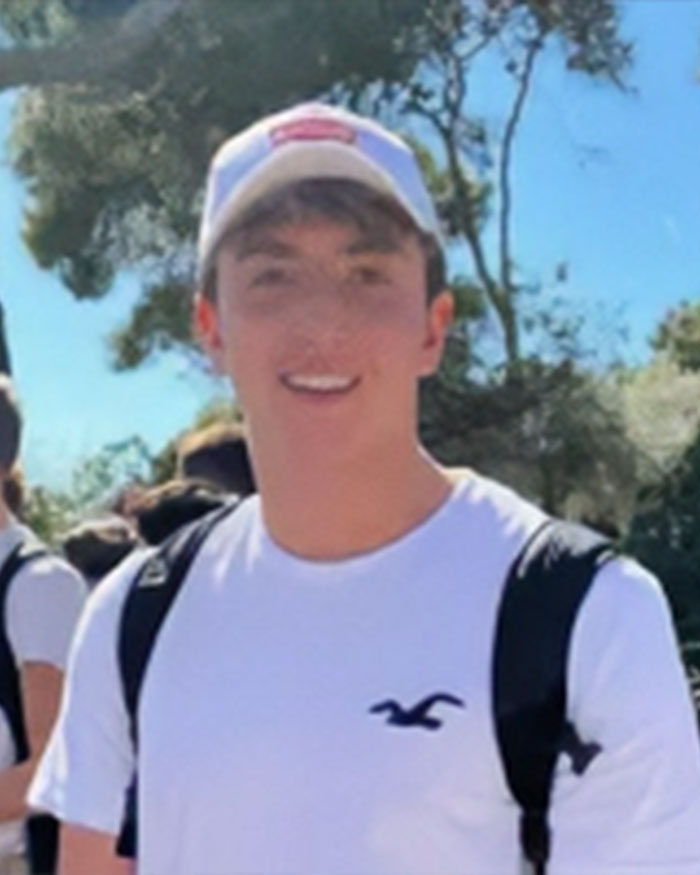 Star water polo player wearing a white shirt and cap outdoors, addressing claims of an underwater incident with a teammate. Star water polo player wearing a white shirt and cap outdoors, addressing claims of an underwater incident with a teammate.