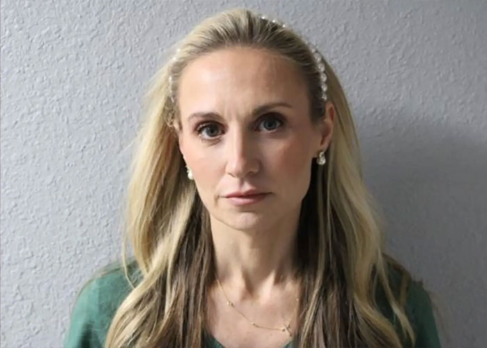 Former mayor Misty Roberts with a serious expression, highlighting religious symbols in a mugshot setting.